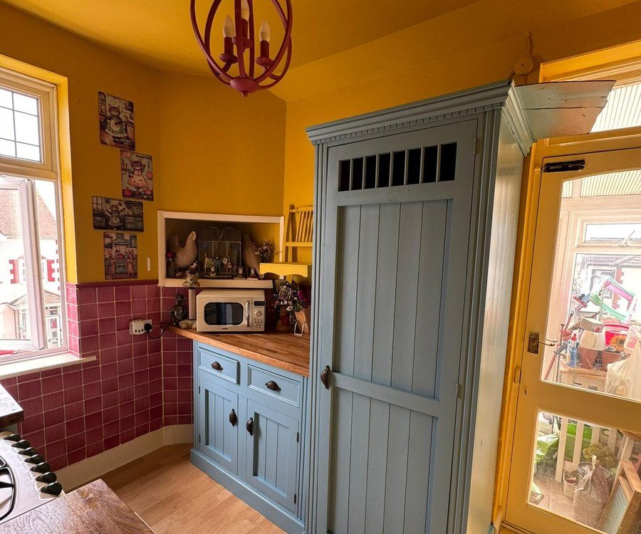 The same larder cupboard after spray painting in soft blue-grey
