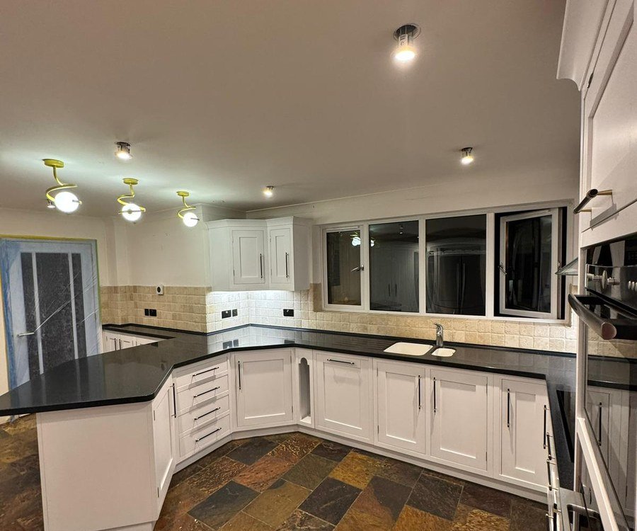 The same kitchen after spray painting, units in white
